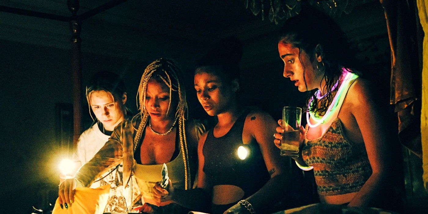 A group of young women with flaslights in Bodies Bodies Bodies.