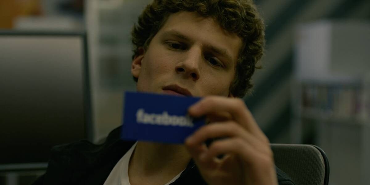 Mark Zuckerberg looking at a Facebook business card on The Social Network