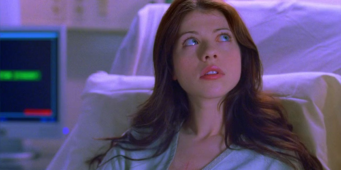 Michelle Trachtenberg sits in a hospital bed