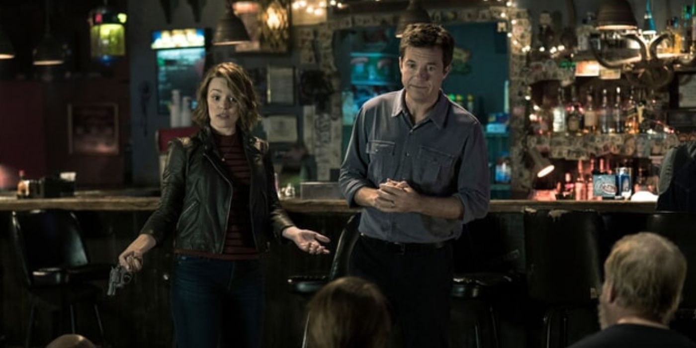 Rachel McAdams and Jason Bateman address bad guys in a bar in Game Night