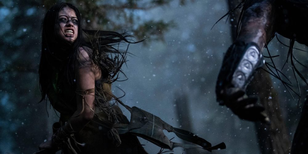 Naru swings her axe at the predator in Prey