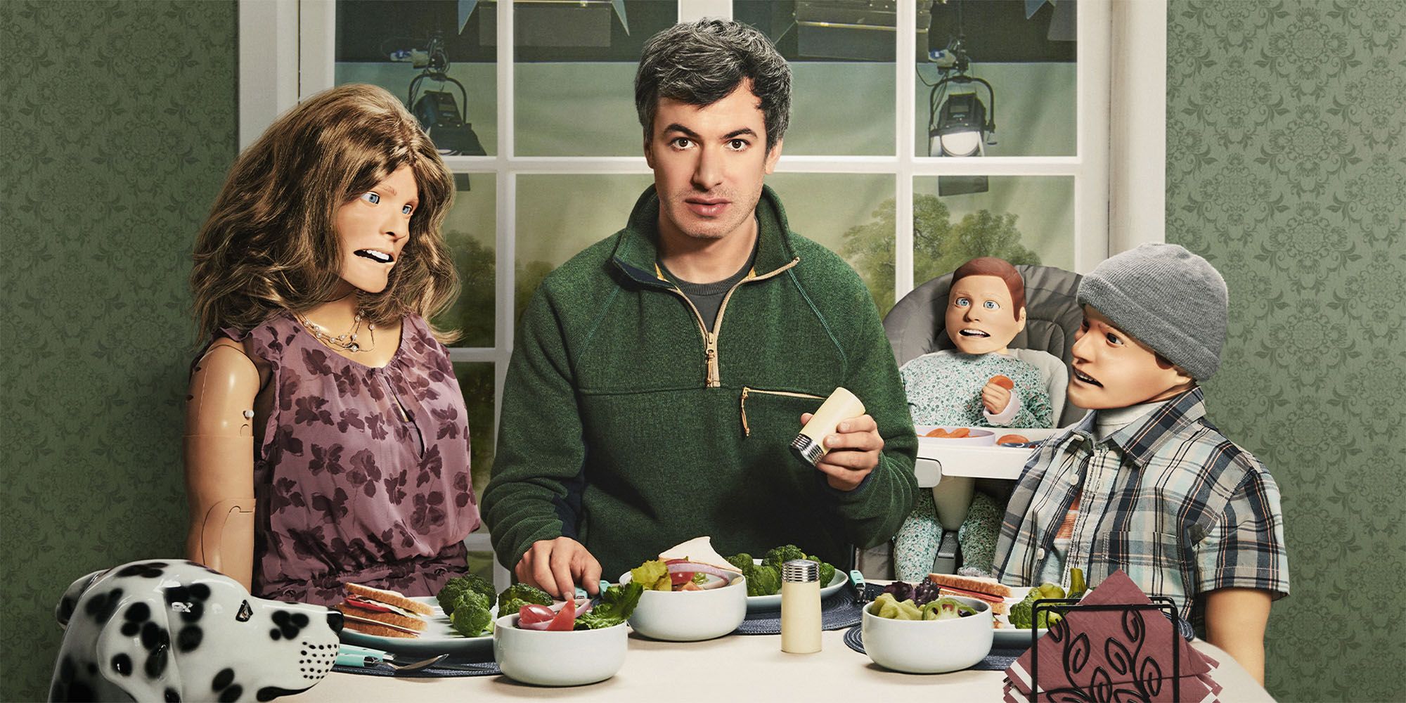 Nathan Fielder in The Rehearsal with bizarre dolls around a table