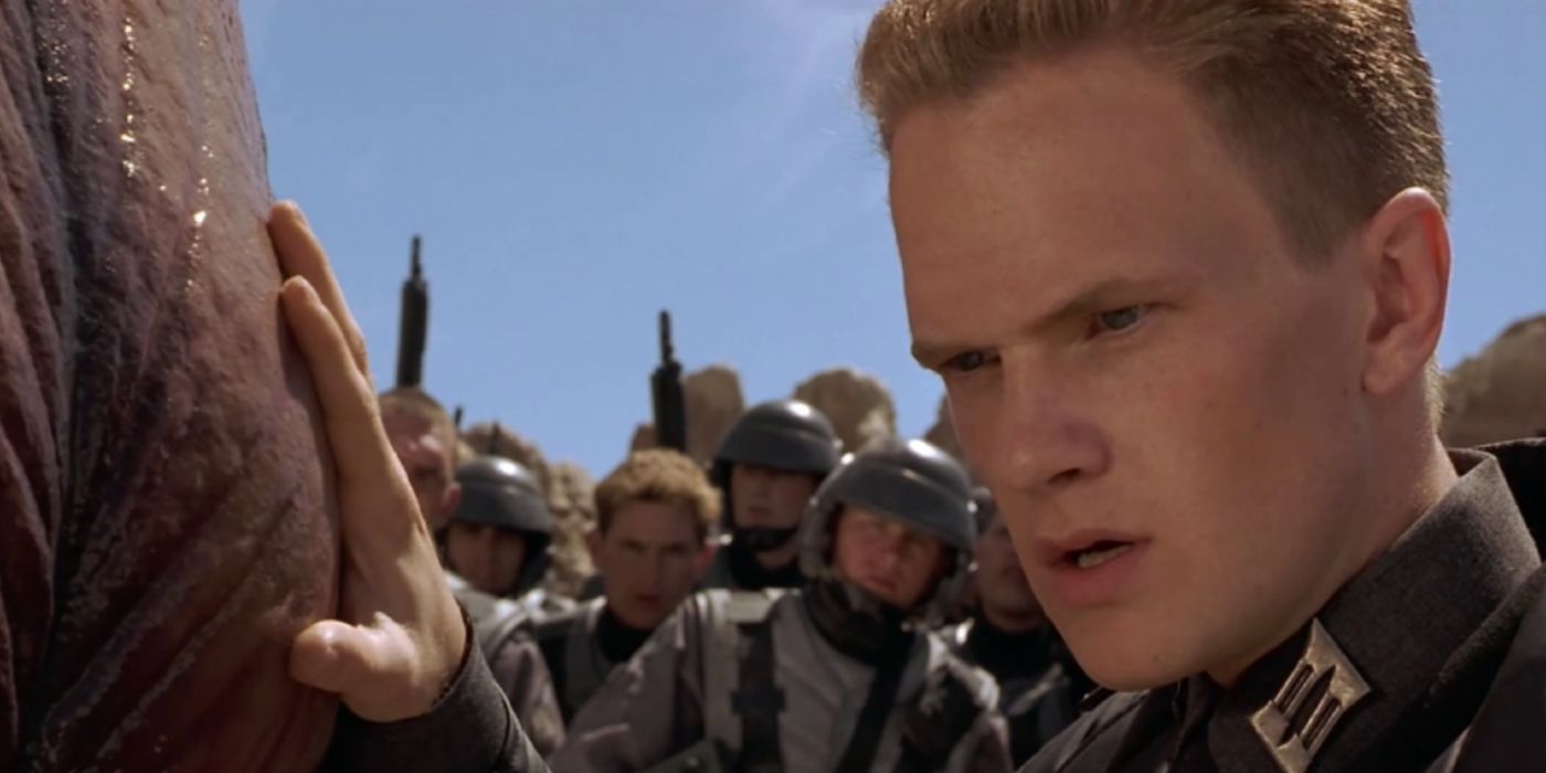 Neil Patrick Harris as Carl Jenkins touching a bug in Starship Troopers 