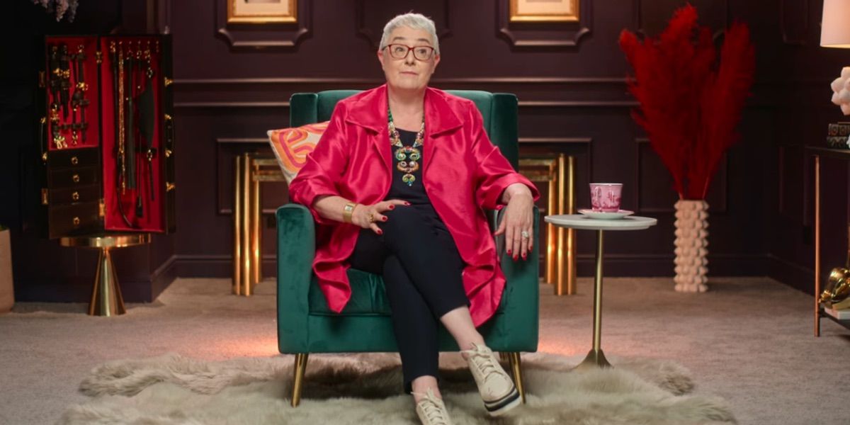 The host of How to Build a Sex Room looks on while speaking