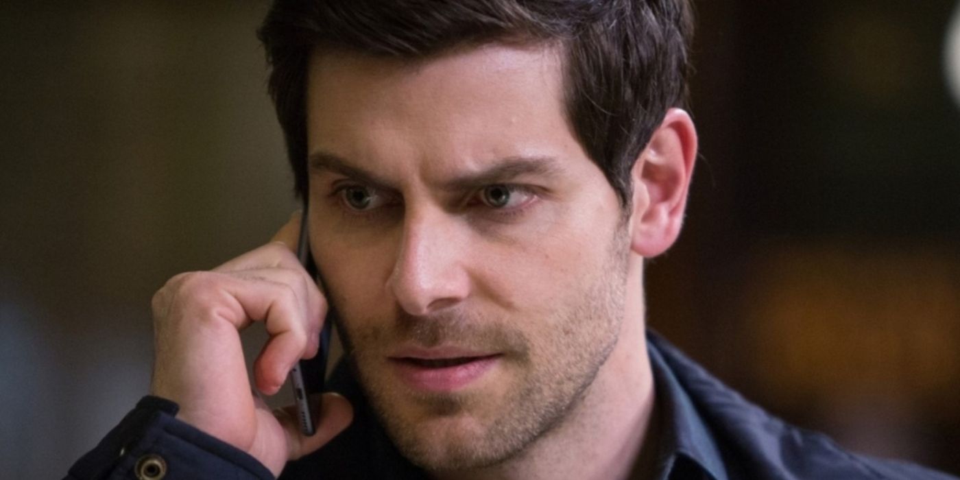 Nick looking serious and talking on the phone on Grimm