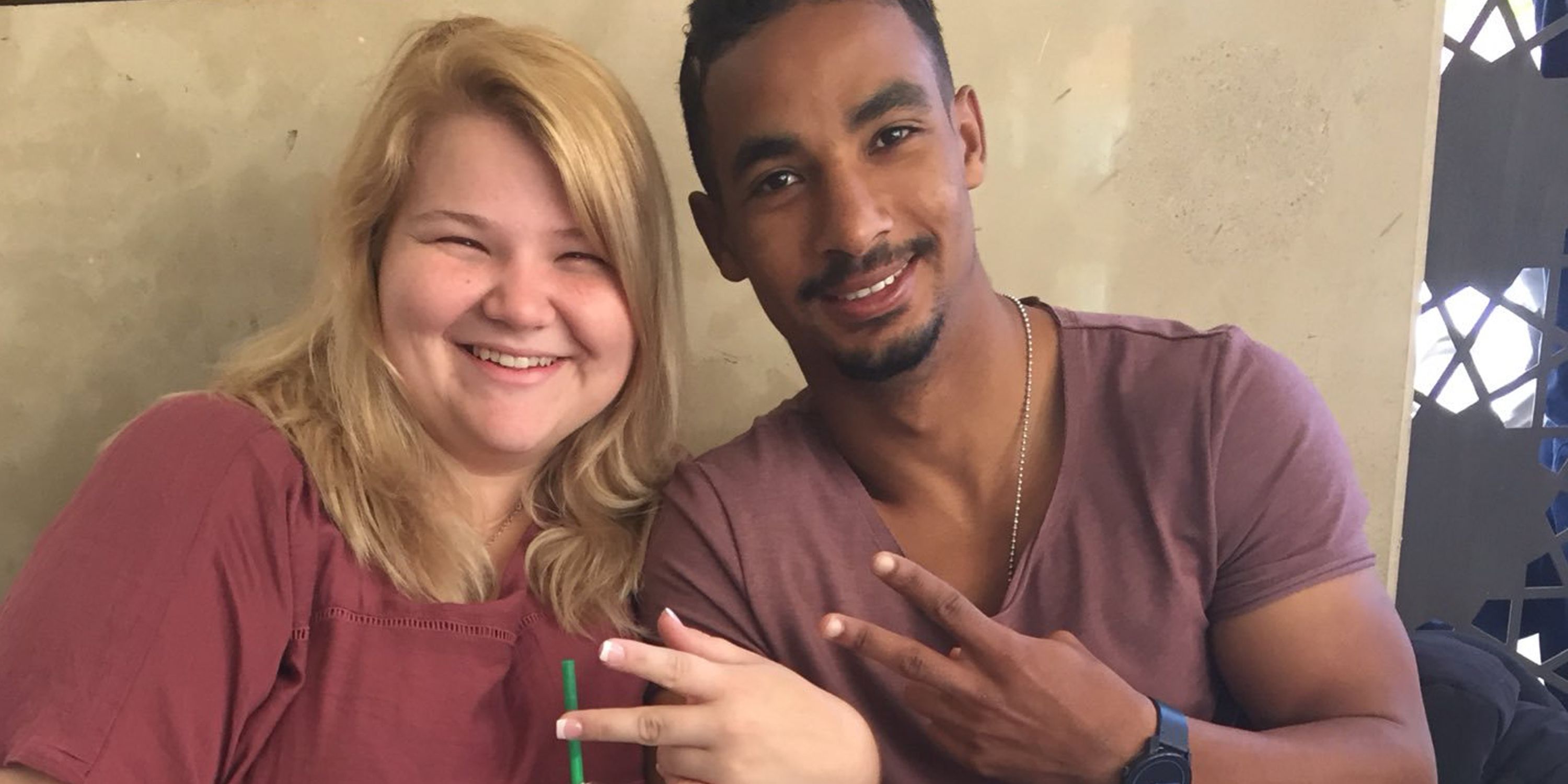 Nicole Nafziger with Azan Tefou both making peace signs on 90 Day Fiance