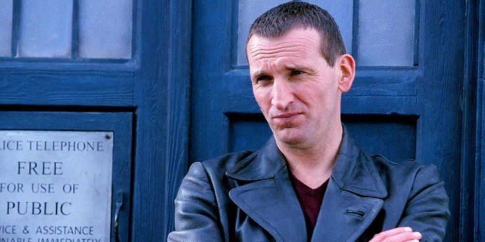 Christopher Eccleston with his arms crossed in Doctor Who