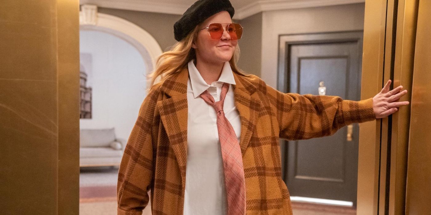 Amy Schumer wearing a plaid coat and walking through a door in Only Murders In The Building
