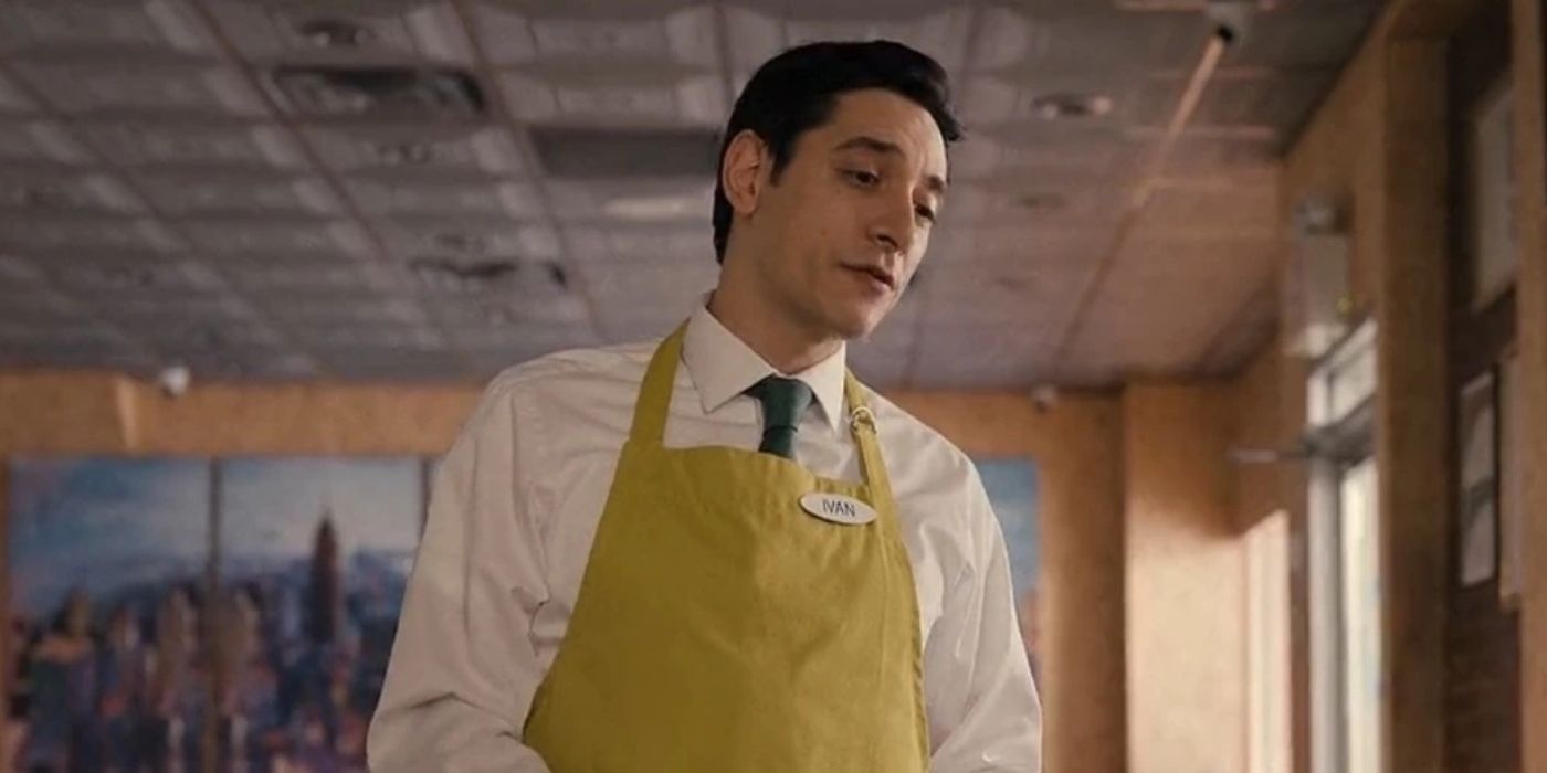 Ivan standing in the diner in his uniform in Only Murders In The Building