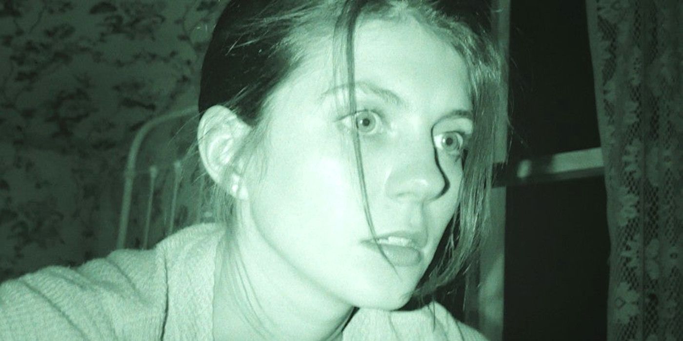 Emily Bader as Margot in Paranormal Activity 7 with a night vision scope looking somewhat alarmed
