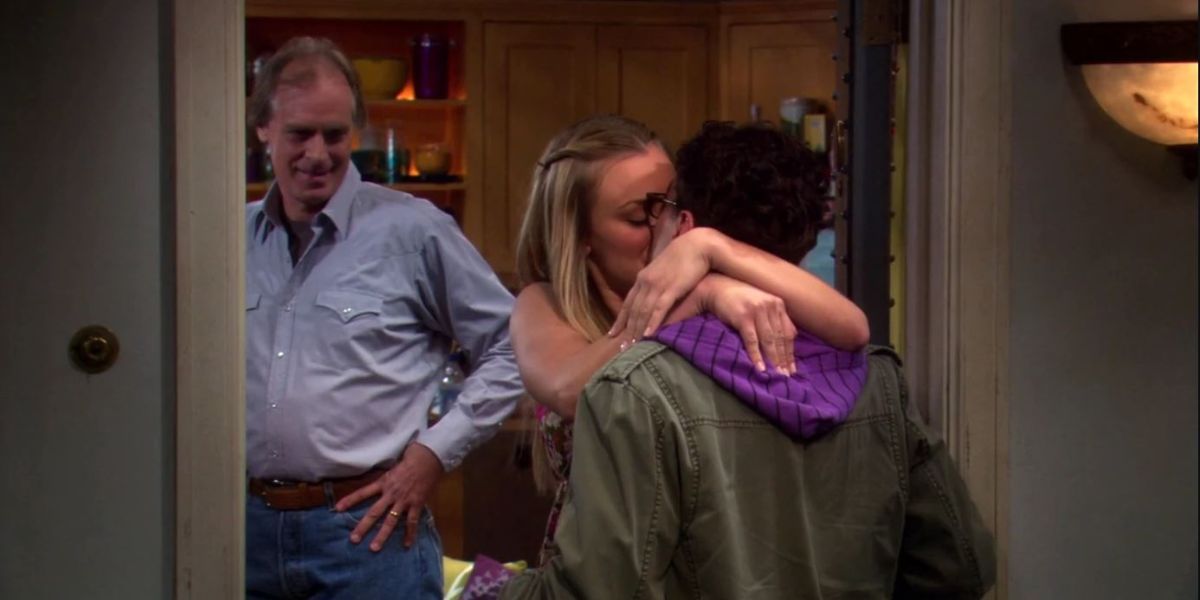 Penny and Leonard kiss outside her apartment while her dad looks on in TBBT