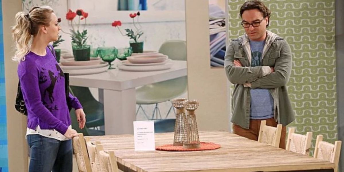 Penny and Leonard in a furniture store looking at a dining room table in TBBT