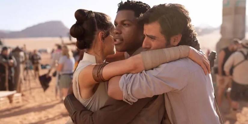 Rey, Finn, and Poe hug one another in The Rise of Skywalker