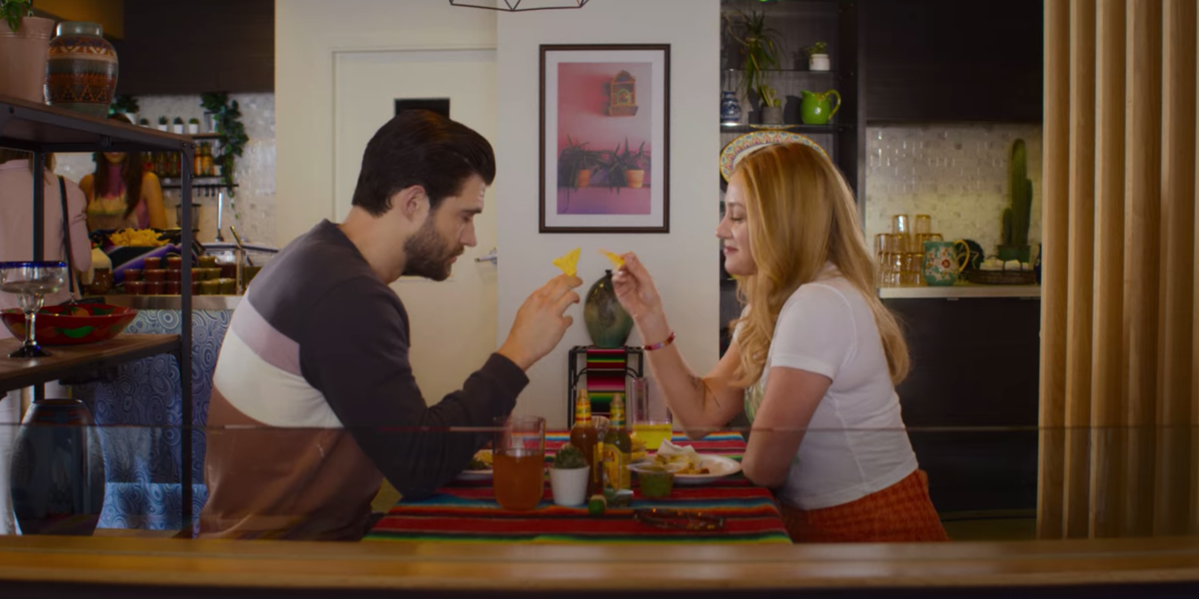 Jake and Natalie toasting with tortilla chips in Look Both Ways
