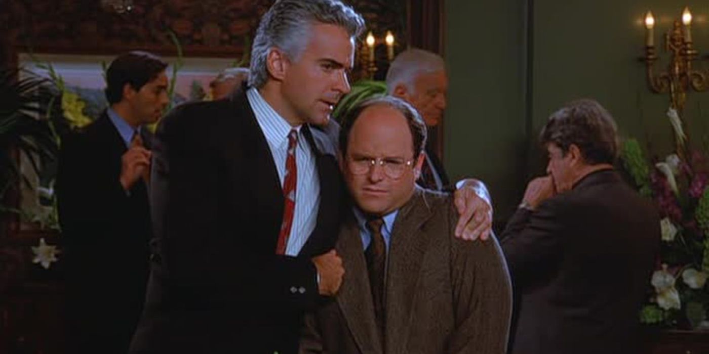 Peterman em pé com os braços em volta de George em Seinfeld