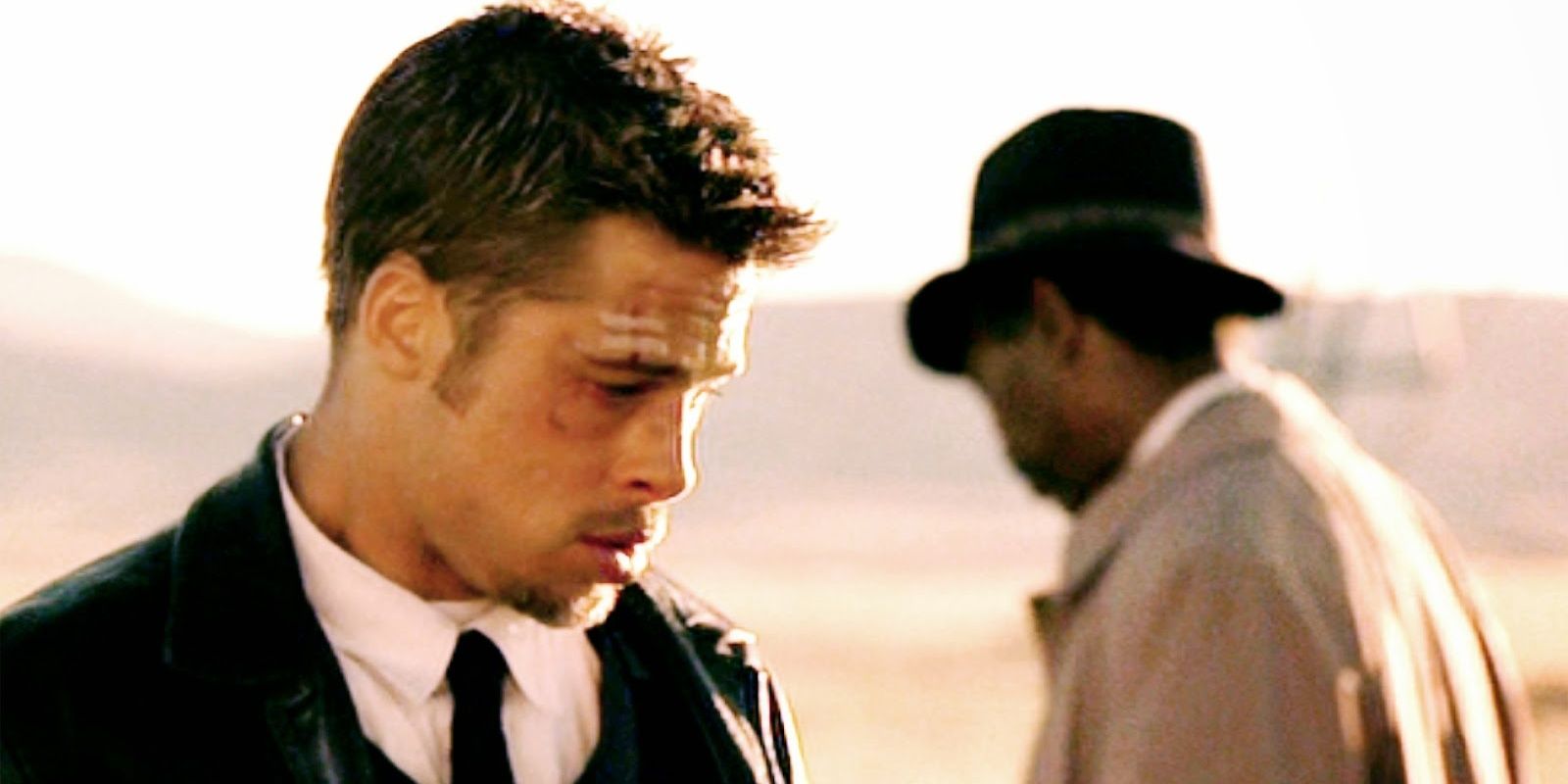 Brad Pitt as Mills with Morgan Freeman as Somerset in the background in Se7en