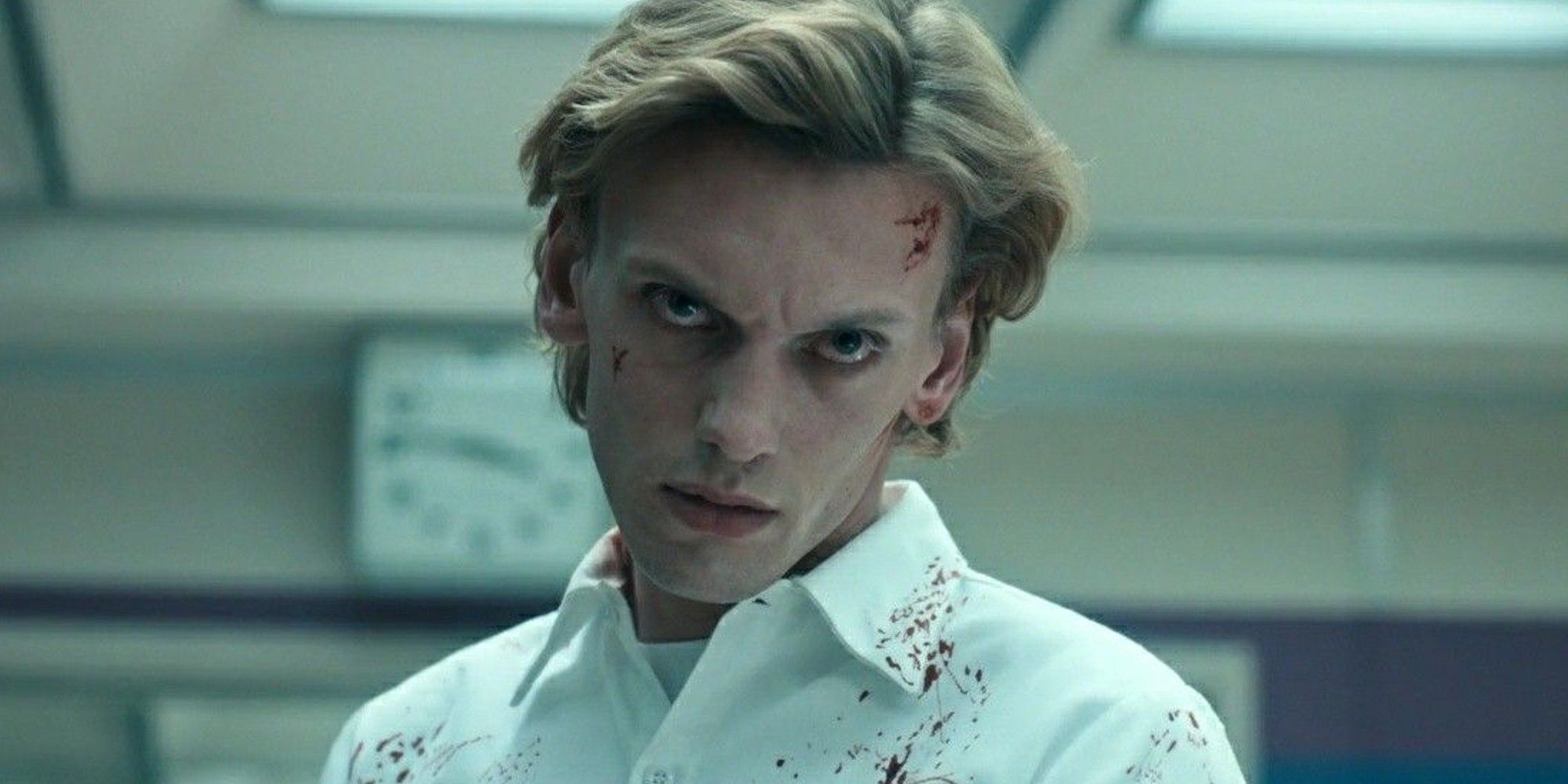 Jamie Campbell Bower as Henry Creel with blood on his face looking evil in Stranger Things.