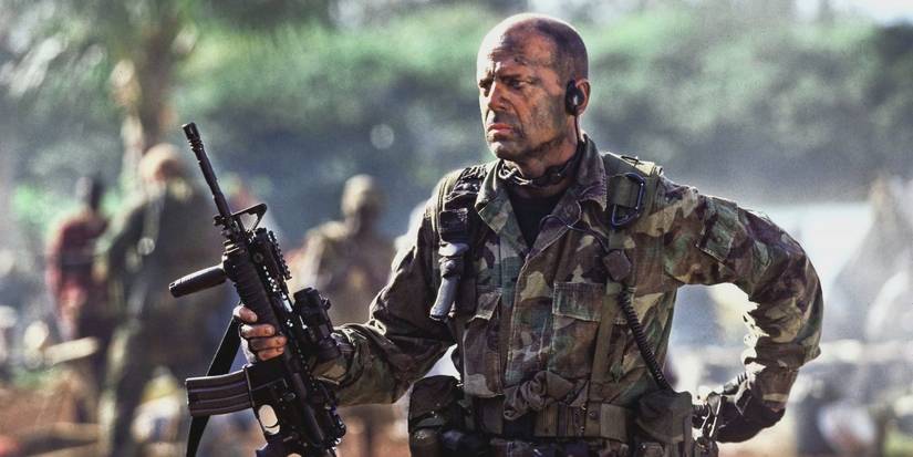A.K. Waters in camouflage and holding a rifle in Tears Of The Sun
