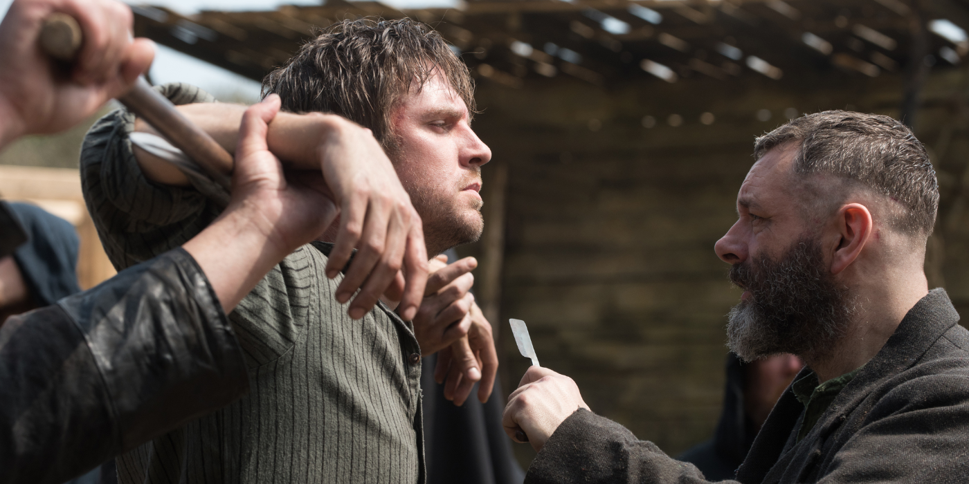 Quinn threatening a man with a razor in Apostle