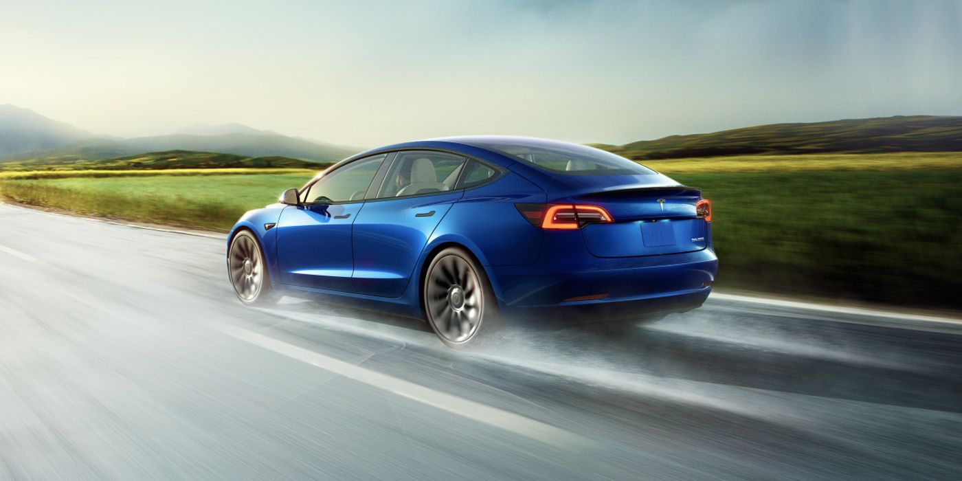 A Tesla Model 3 Rearview going down a highway.