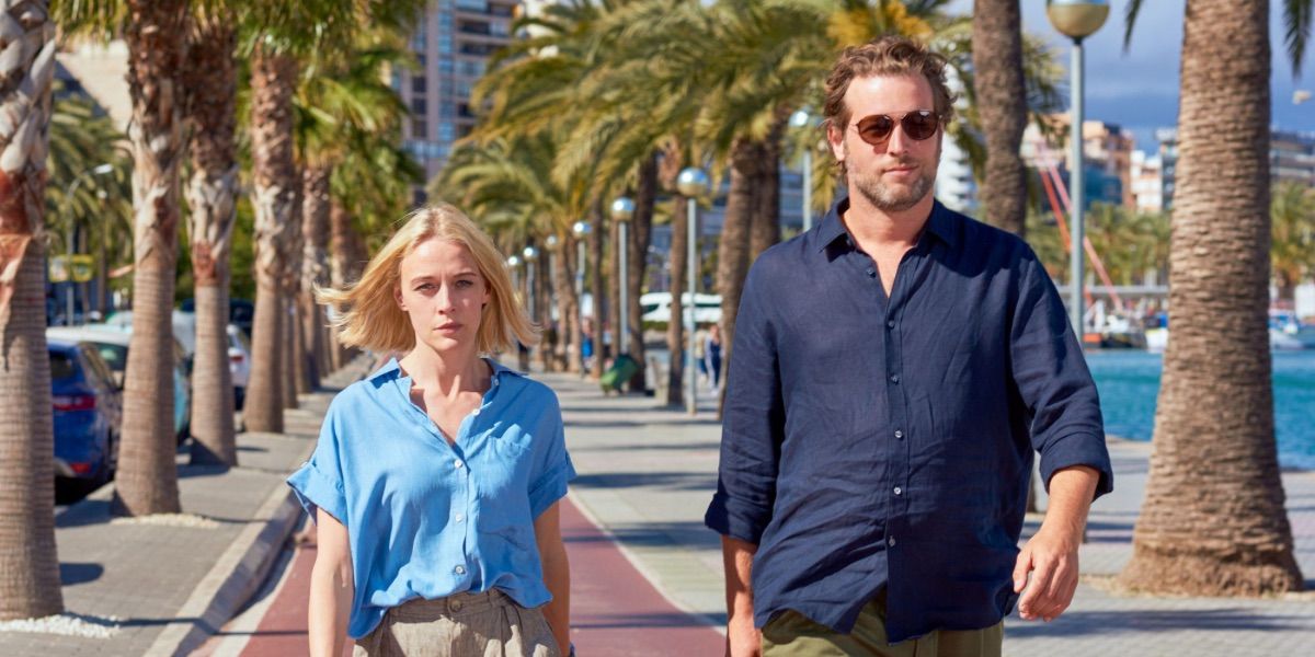 Two detectives walk in front of the water in The Mallorca Files