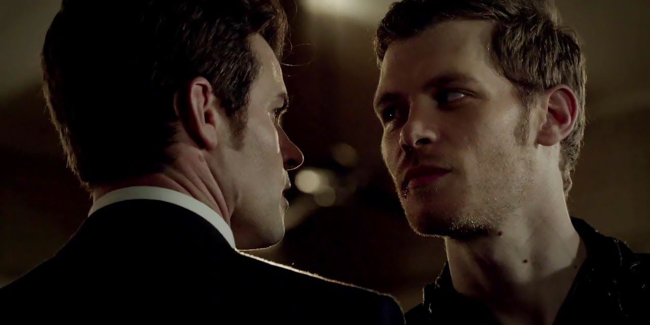 Elijah and Klaus Mikaelson staring at each other.