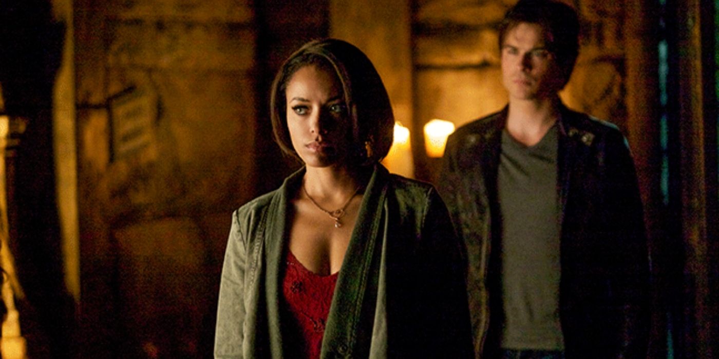 Damon standing behind Bonnie on The Vampire Diaries