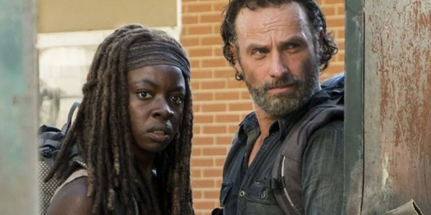 Rick and Michonne take cover behind a wall in The Walking Dead.