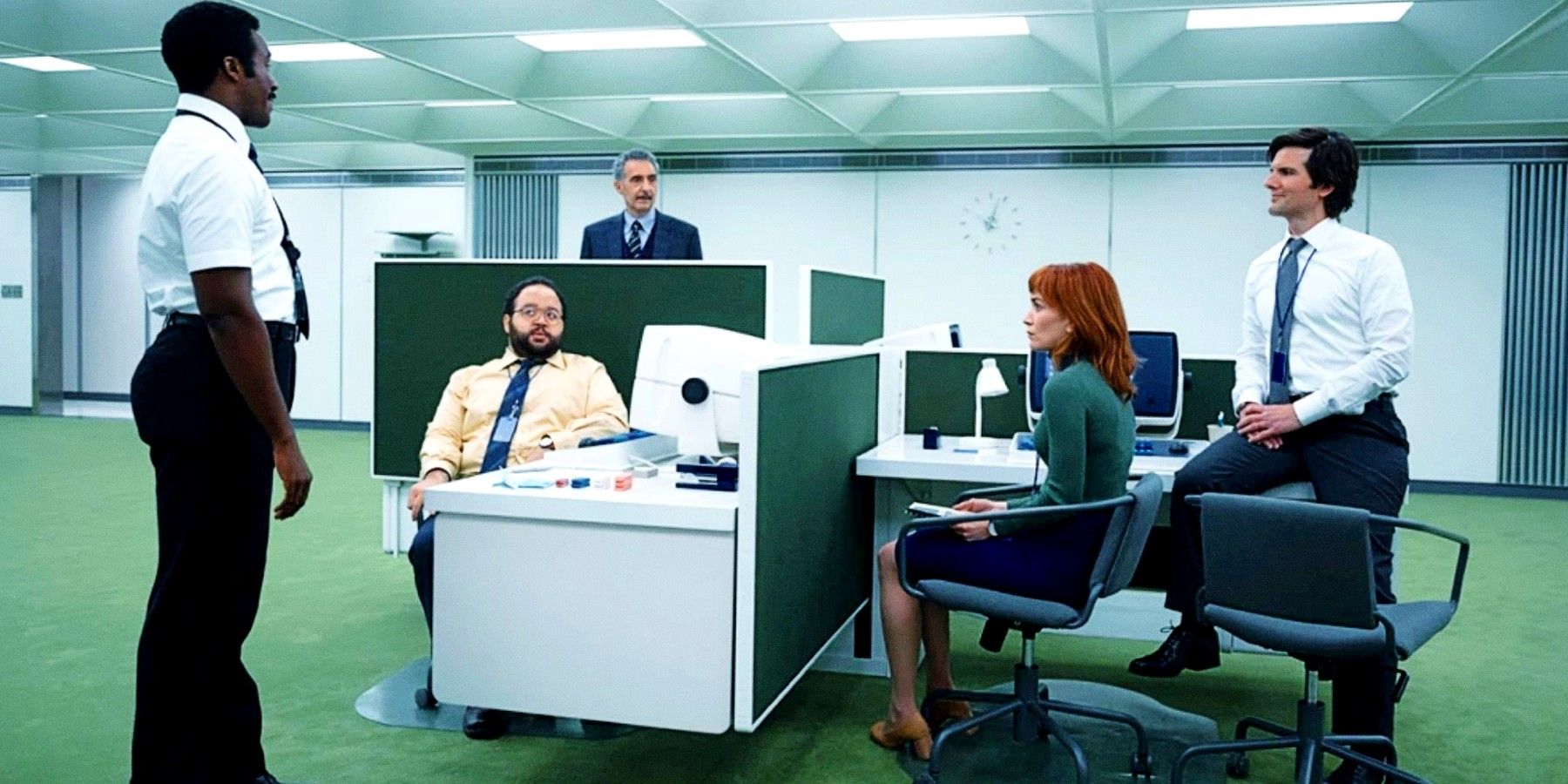 The cast of Severance sitting in an office setting.