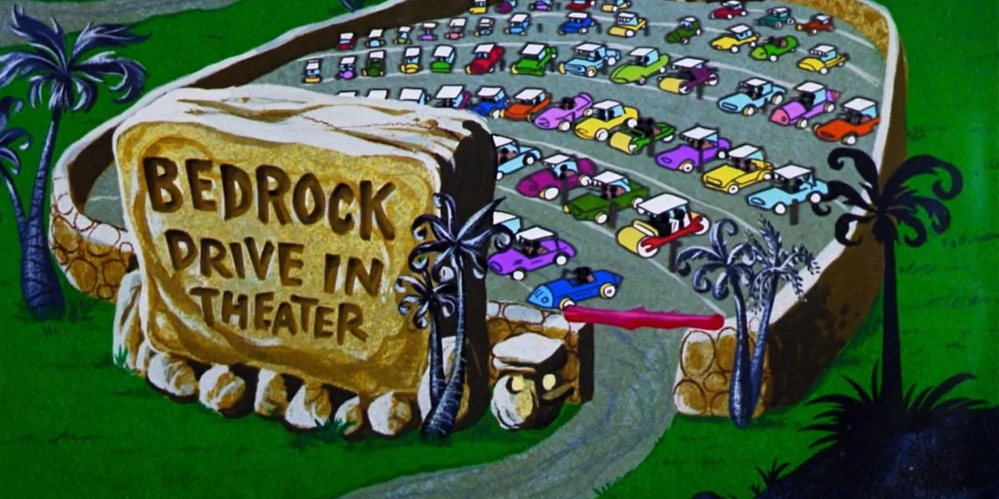 The Flintstones: Bedrock drive in theater with cars parked inside