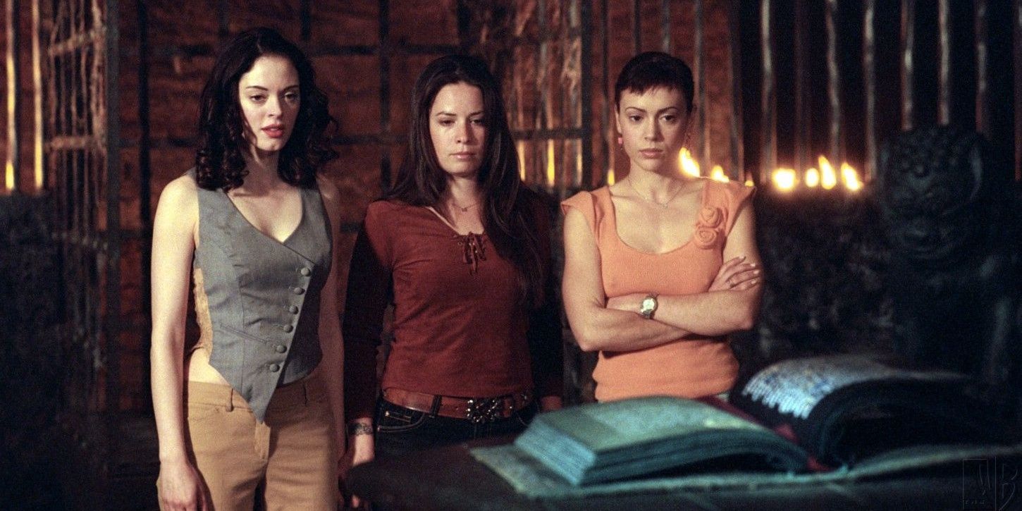 The sisters in Charmed staring at a large book