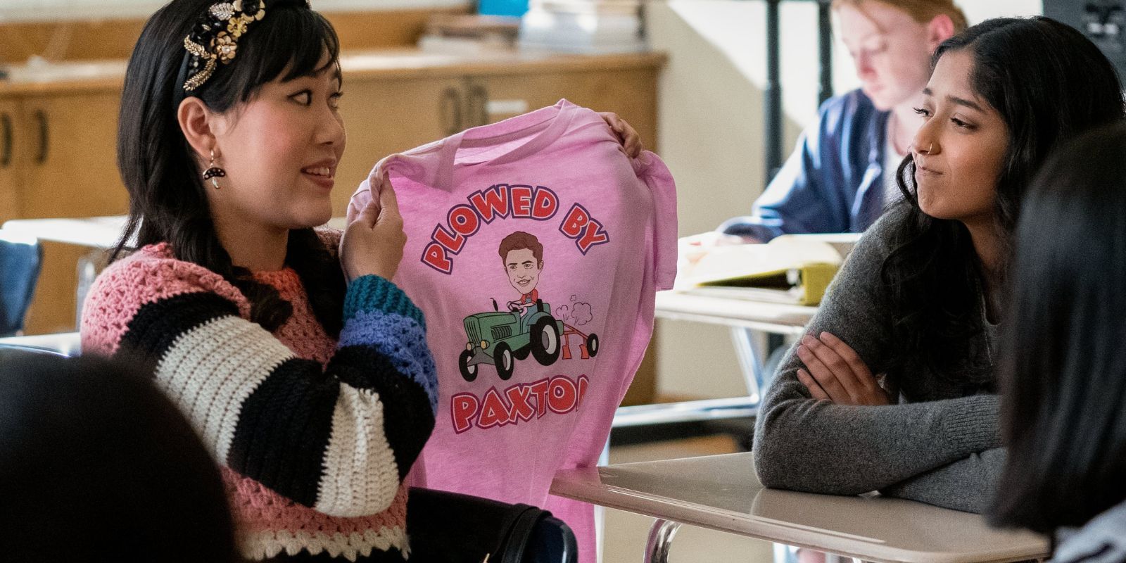 Eleanor holds tshirt up in class with Devi