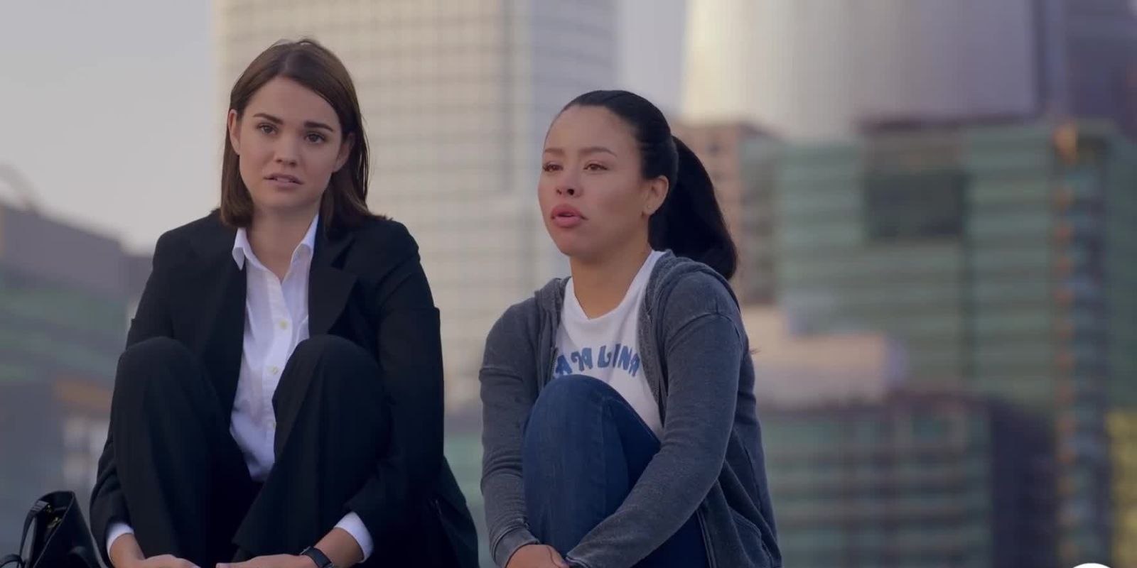 Mariana and Callie sit on roof of their apartment