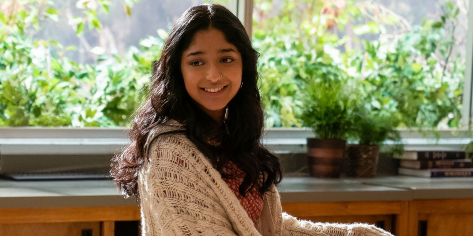 NHIE Devi smiling in front of window