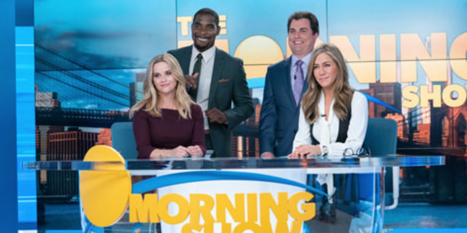 TV Anchors smiling at desk in The Morning Show
