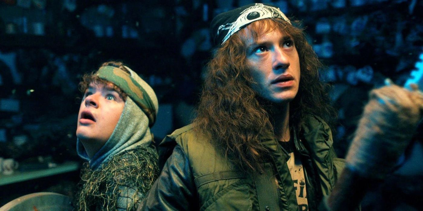 Eddie and Dustin looking around in Stranger Things.