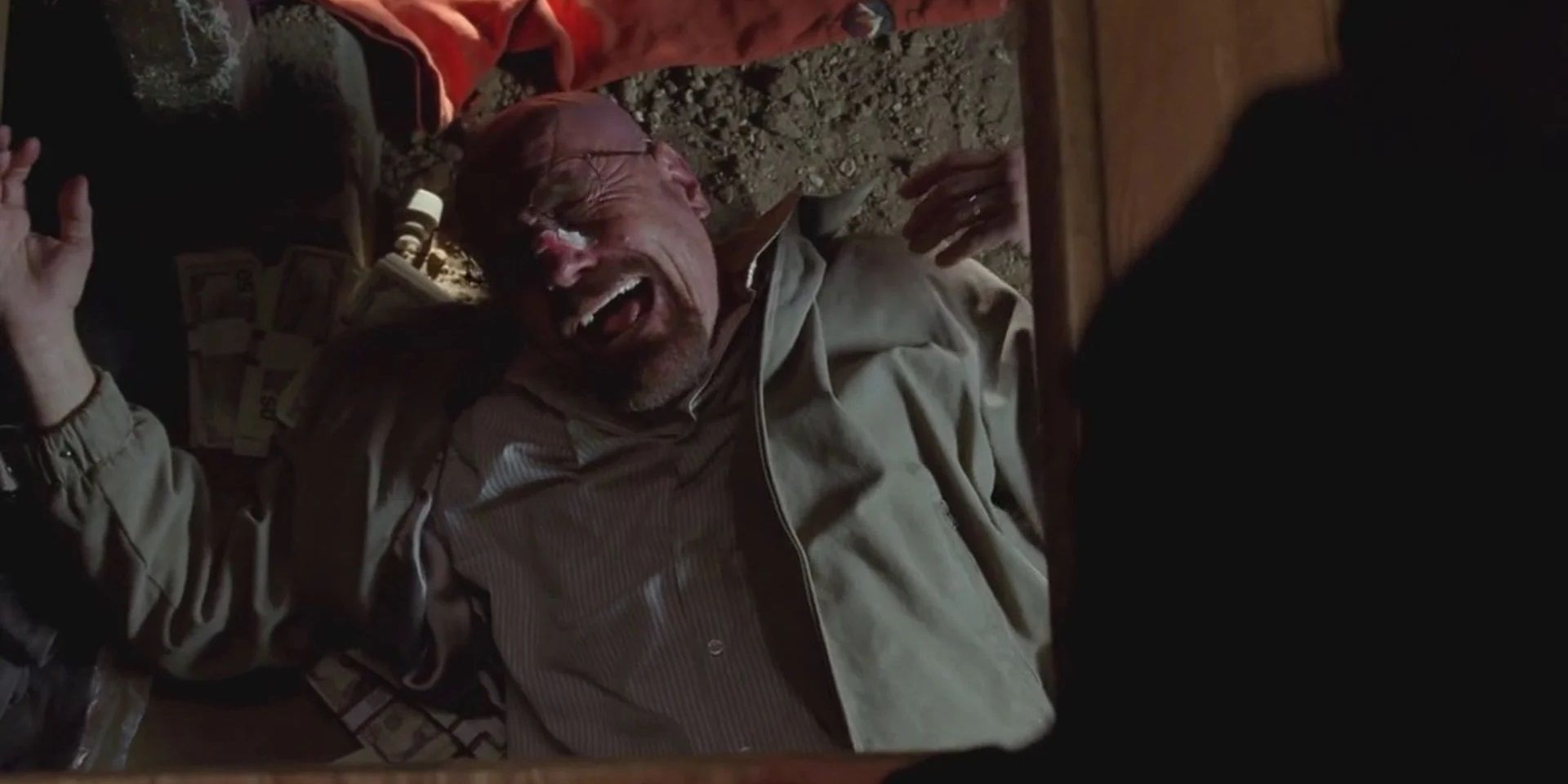 Walt laughs in the crawl space in Breaking Bad