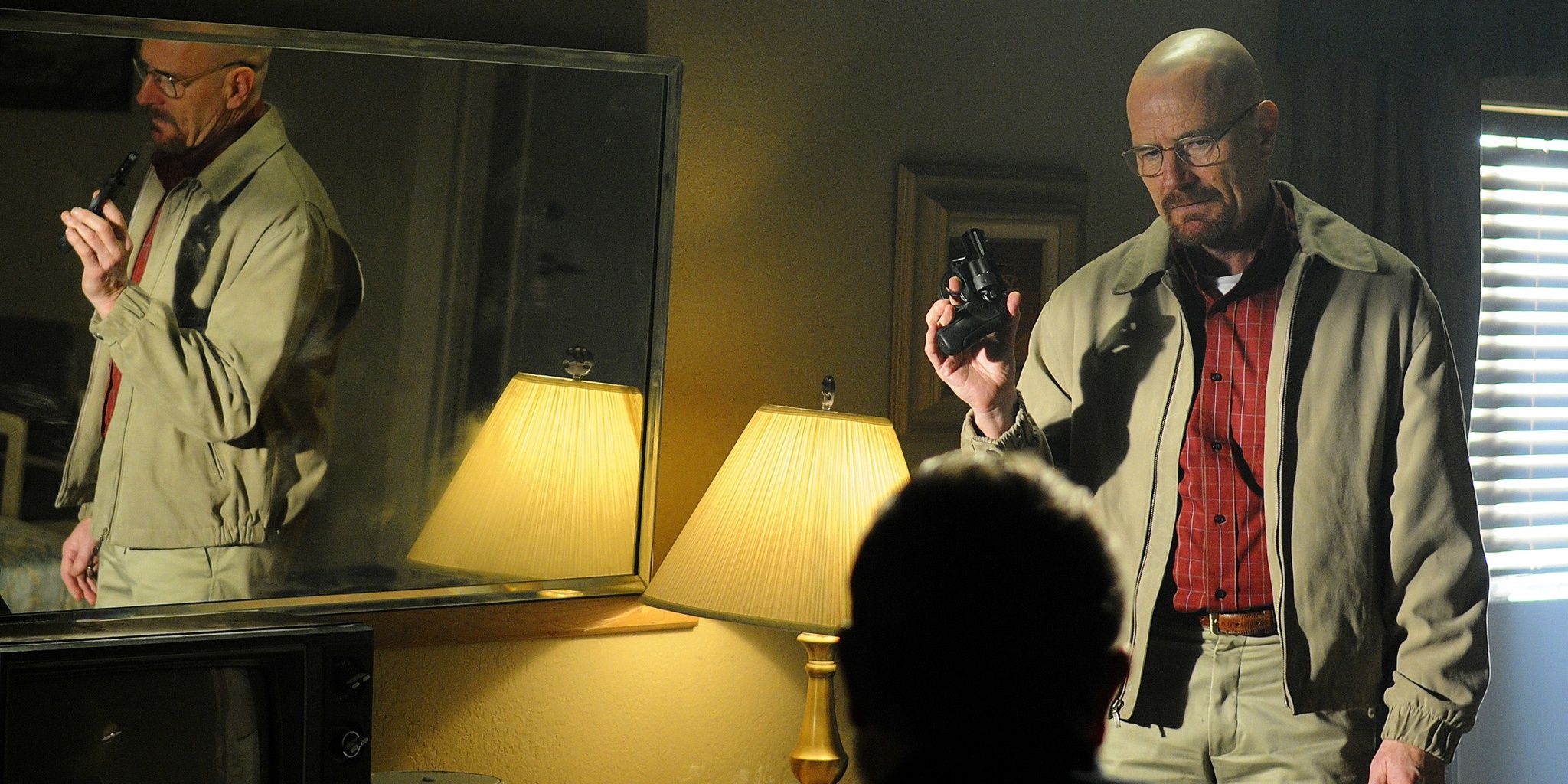 Walter White holding a gun in Breaking Bad 