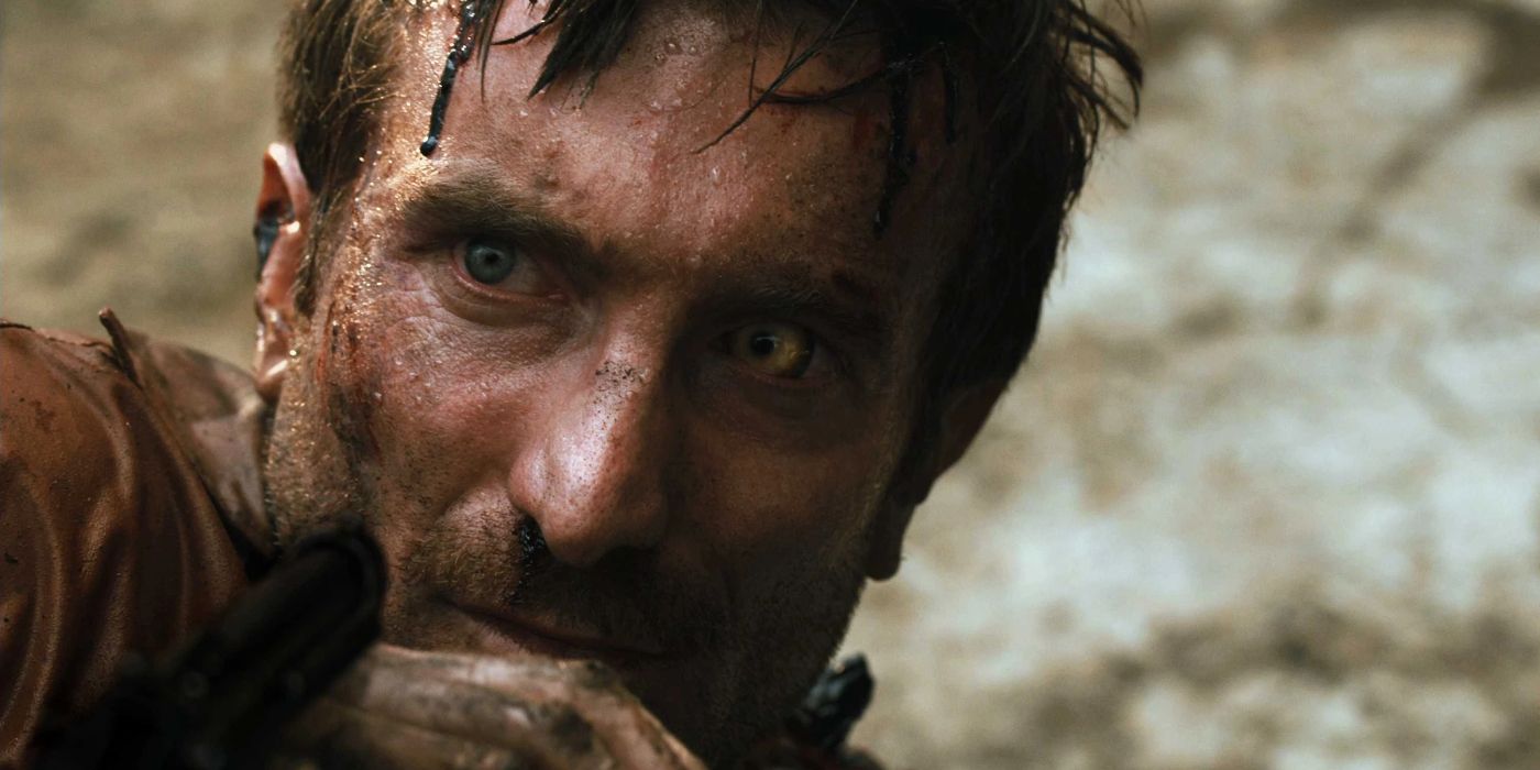 Sharlto Copley hiding behind his hand in District 9