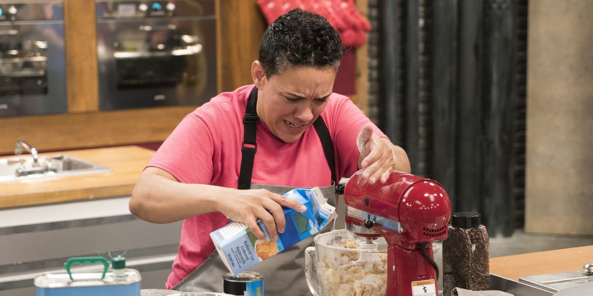 Worst Bakers In America contestant pouring milk from a carton into a stand mixer