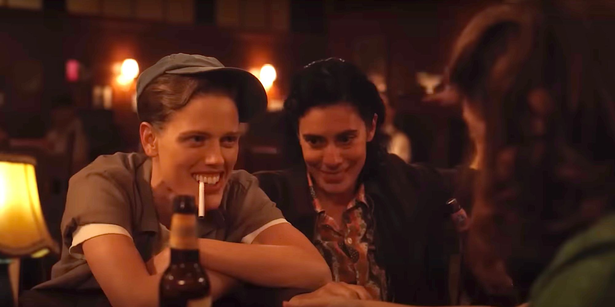 Jess, Lupe, and Carson sharing a drink and laughing at a bar in A League of Their Own series