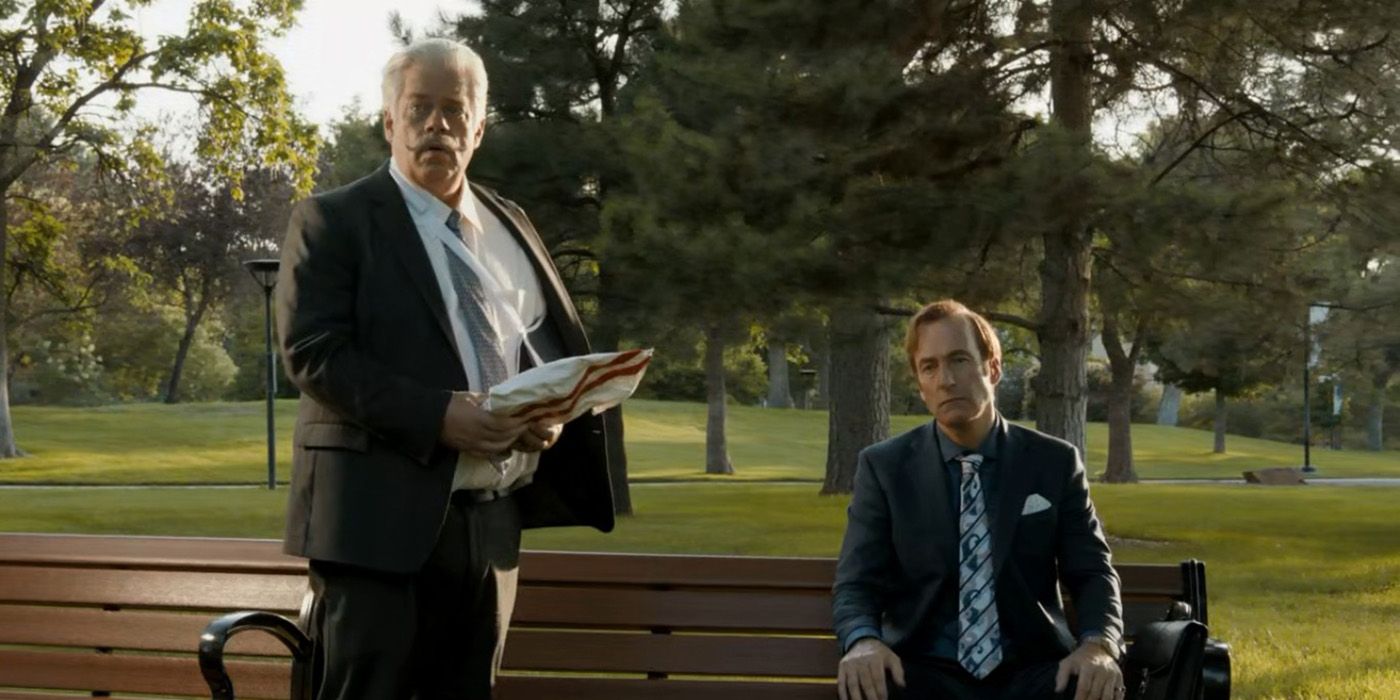 The man impersonating a judge with a broken arm and Saul sitting on a park bench in Better Call Saul.