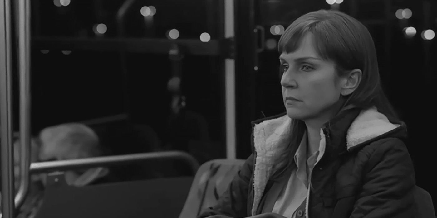 Kim staring into space, sitting on a bus in a black and white scene from Better Call Saul.