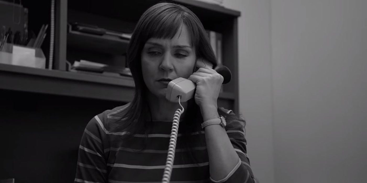 Kim is in her office holding her phone to her ear and looking upset in the black and white scene from Better Call Saul.