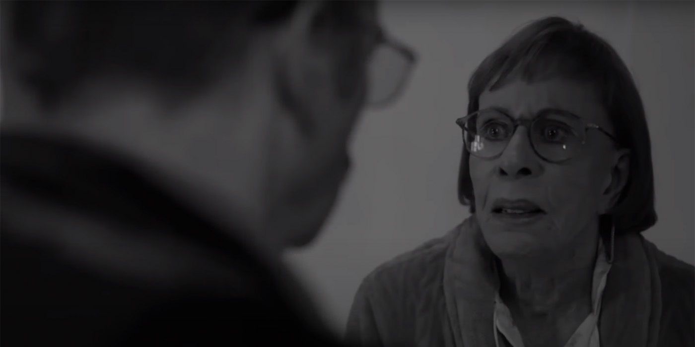 Marion looking terrified, Gene scowling at her in the foreground in a black and white scene from Better Call Saul.