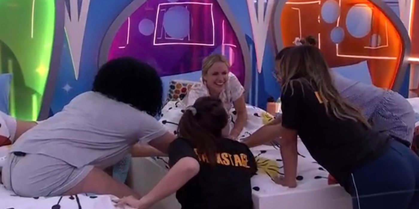 The ladies in the Girls Girls alliance on Big Brother 24, putting their hands together while on the bed.