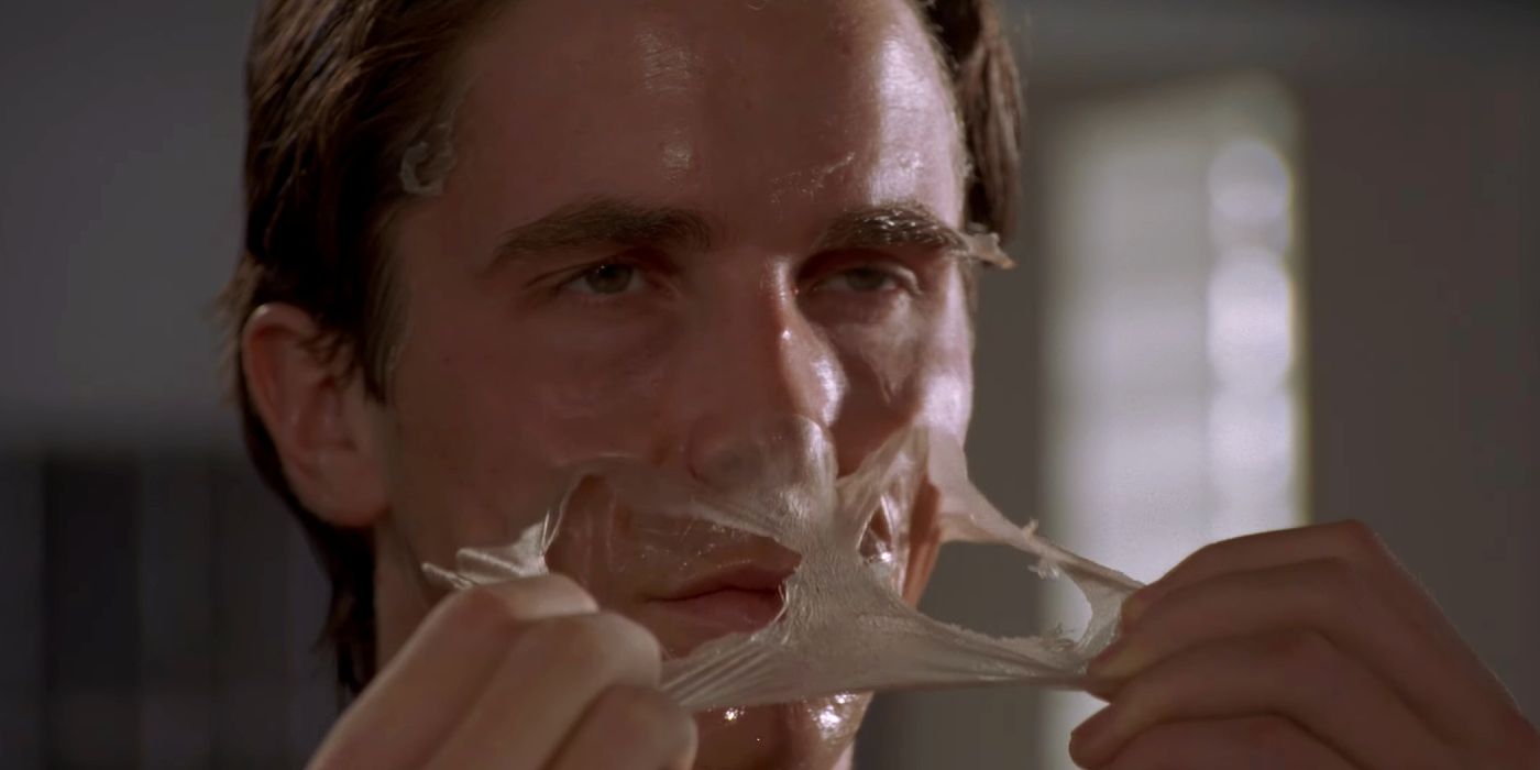 American Psycho's Patrick Bateman (Christian Bale) peels a face mask.