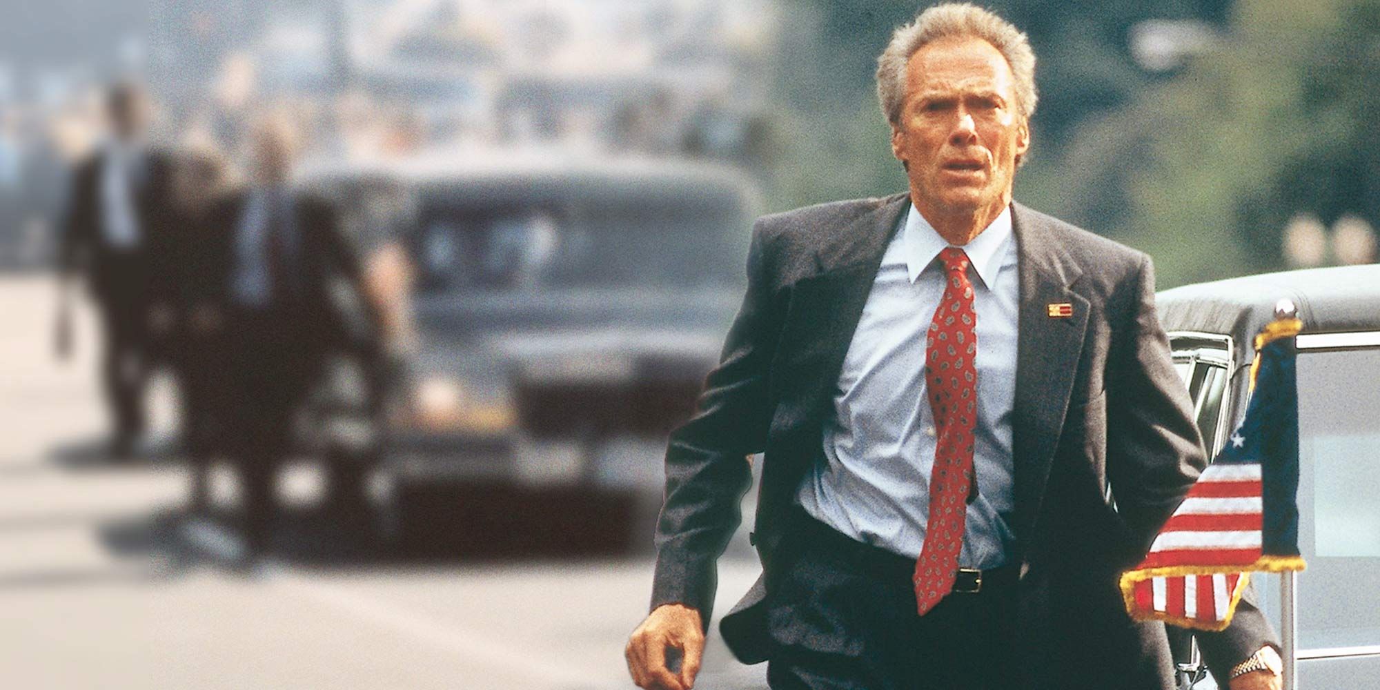 Clint Eastwood walking alongside a motorcade in In the Line of Fire