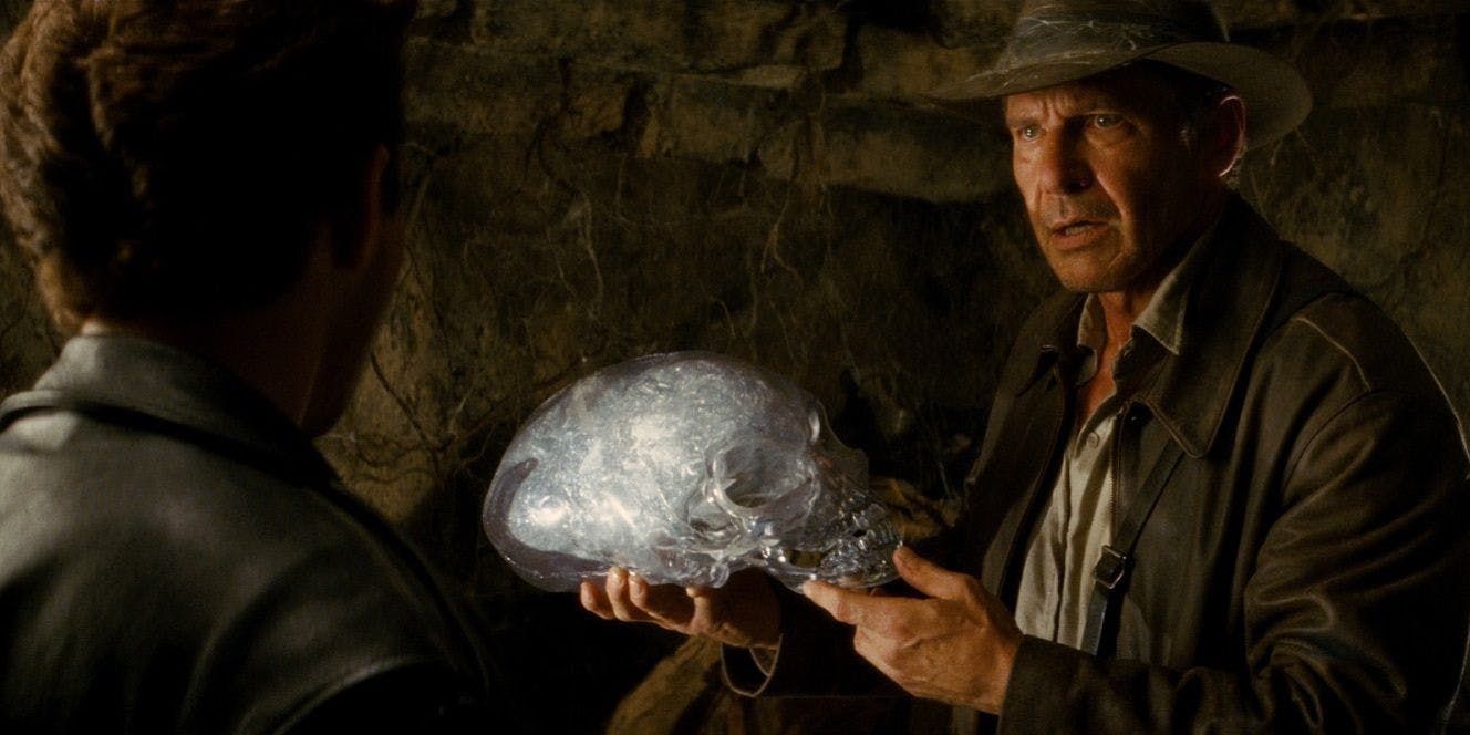 Indy holds a skull in Indiana Jones Kingdom of the Crystal Skull