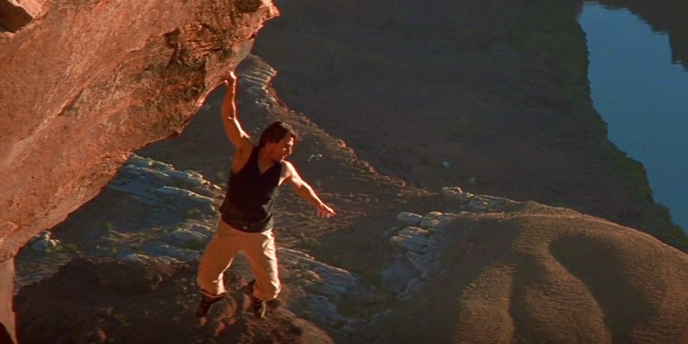 tom cruise as ethan hunt hanging off mountain mission impossible 2
